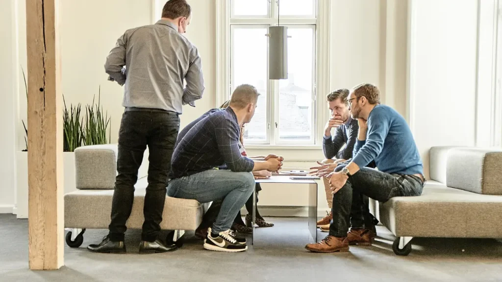 Sales trainer, David Craig White monitoring a group of salespeople during a training exercise
