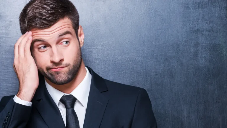 A man in a suit looking doubtful
