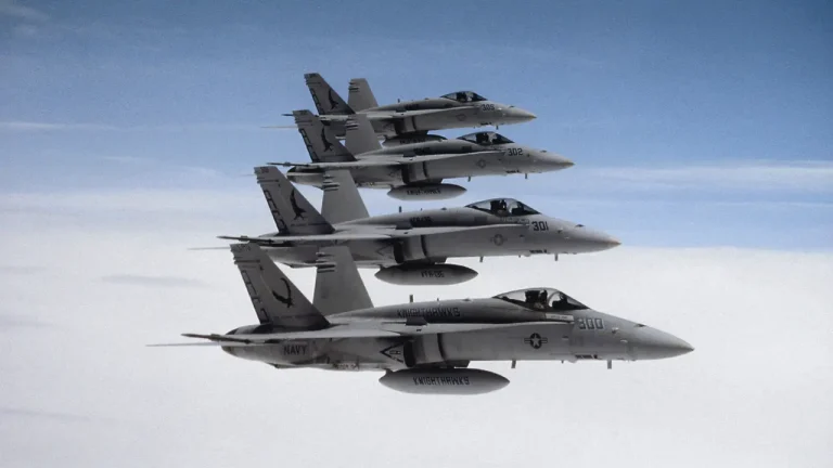 Four fighter jets flying in formation